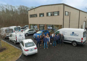 The Oakley Home Access team and fleet of vehicles at the Narragansett, RI showroom.