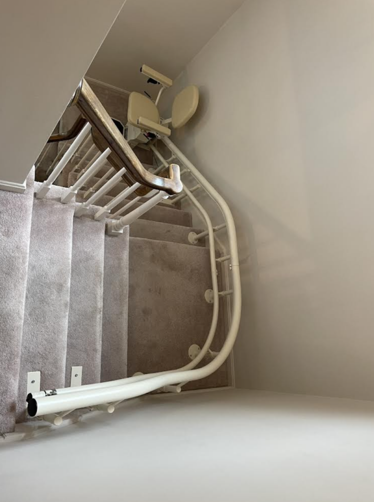 Curved Stair Lift Following a Carpeted Staircase